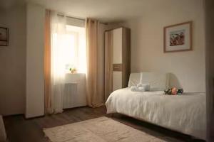 a bedroom with a white bed and a window at Glamorous flat in Mertzwiller in Mertzwiller