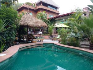 a swimming pool in front of a building with a resort at Casa d'Lobo Hotel Boutique in Malinalco