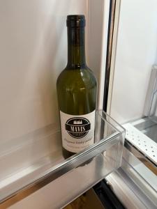 a bottle of wine is sitting in the refrigerator at Apartmán Mavis in Kašperské Hory +16 photos