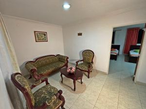 a living room with chairs and a couch and a table at Hotel C Villa Plaza in San Gil +57 photos