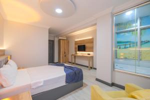 a bedroom with a bed and a view of the ocean at Kar Hotel in Mersin