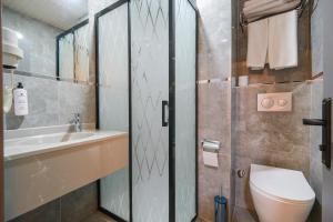 a bathroom with a toilet and a sink at Kar Hotel in Mersin