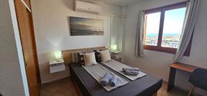 a bedroom with a bed with shoes on it at Costa Blanka resident apartman in Torrevieja
