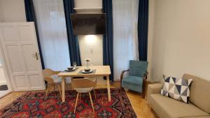 a living room with a table and chairs and a couch at City Park Home in Budapest +40 photos
