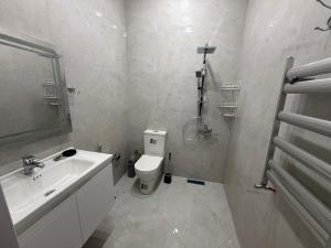a white bathroom with a sink and a toilet at Melhem Twin Homes in Şamaxı +23 photos