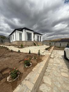a house with some flowers in front of it at Melhem Twin Homes in Şamaxı