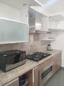a kitchen with a toaster oven and a microwave at Luxury Apartment San Isidro in Lima