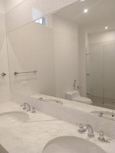 a bathroom with two sinks and a mirror at Luxury Apartment San Isidro in Lima +22 photos