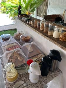 a table with pastries and other food items on it at Morada do Vento in Guriú