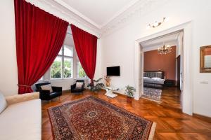 a living room with red curtains and a couch at La Maman- Only self check-in in Braşov