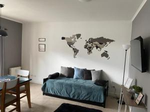 a living room with a bed and a world map on the wall at Altos Patagonia in Río Gallegos