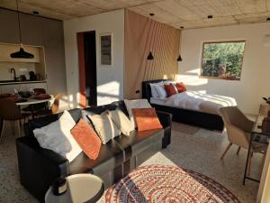 a living room with a couch and a bed at House B in Dekani