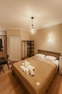 a bedroom with a large bed with towels on it at Hotel Marioni in Tbilisi City +54 photos