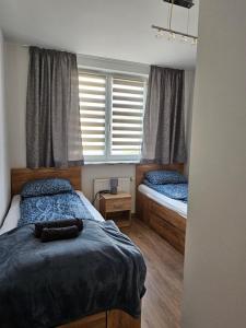 Ένα ή περισσότερα κρεβάτια σε δωμάτιο στο Grey Apartment