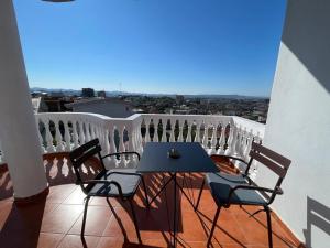 a table and chairs on a balcony with a view at Vila Nikollaj in Kamëz