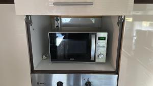 a microwave oven in a kitchen in a cabinet at Appartement Stein 1 OG in Fritzlar