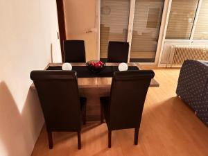a dining room table with two chairs and a bowl on it at Appartement Stein 1 OG in Fritzlar