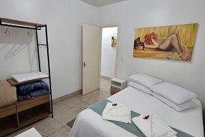 Katil atau katil-katil dalam bilik di Casa com Lareira e Ar Condicionado Bem Localizada