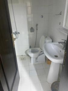 a white bathroom with a toilet and a sink at الرياض شقه للايجار in Riyadh