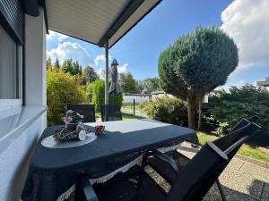 a table with a blue table cloth on a patio at Schleibungalow Nr15 zw Ostsee und Schlei in Kappeln
