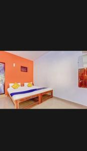 a bedroom with a bed and a table in it at Om Ganesh Guest House1 in Arambol