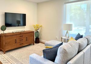 a living room with a couch and a flat screen tv at The Loft Retreat in Southampton