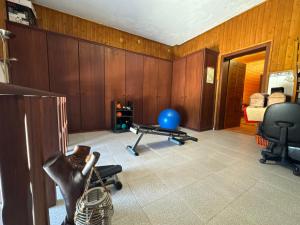 a room with wooden walls and a room with chairs and a table at Quinta dos Silvas in Santa Maria da Feira