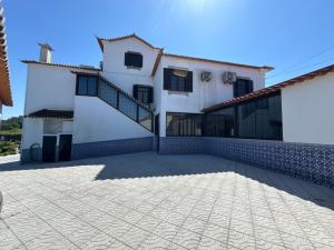 a large white house with a patio at Quinta dos Silvas in Santa Maria da Feira