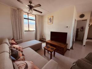 a living room with a person laying on a couch at Casa Colina Tenerife in San Isidro