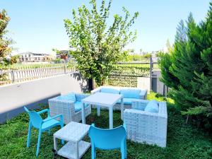 a patio with blue chairs and a table and chairs at OLDSKOOL TOWN HOUSES 15 minutes walk to LARA beach in Lara