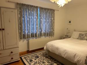 a bedroom with a bed and a large window at Breathtaking view in Carrigart