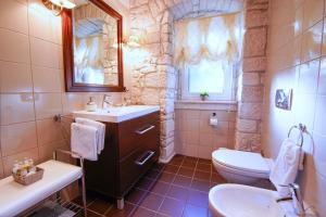 a bathroom with a sink and a toilet and a window at Villa Shiraz in Selca +51 photos