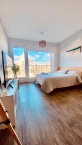 a bedroom with a bed and a desk with a television at Premium Studio in Downtown in Neuquén