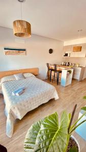 a bedroom with a bed and a dining room at Premium Studio in Downtown in Neuquén