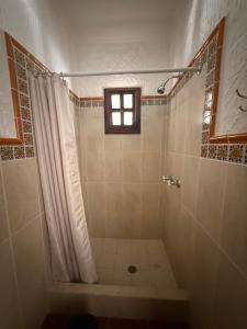 a bathroom with a shower and a window at Casa del Sol Antigua in Antigua Guatemala