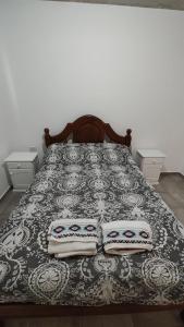 a bedroom with a bed with two pillows on it at Calixto C in Cordoba