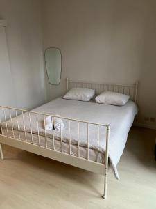 a bedroom with a bed with a mirror on the wall at Flat brussels center in Brussels +4 photos