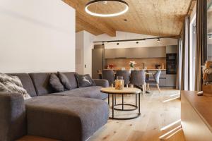 a living room with a couch and a table at Alpenlodge Haus - Summer resort with Schladming-Dachstein Card in Haus im Ennstal