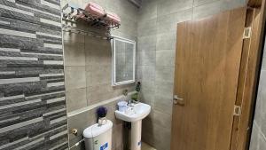 a small bathroom with a sink and a mirror at cozy appartement in Casablanca +66 photos