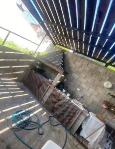 a hose is on the ground next to a building at Lo de Alicia 1 in Estancia Vieja