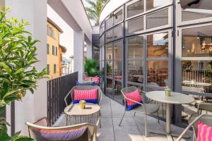 an outdoor patio with tables and chairs at Living Ascona Boutique Hotel in Ascona