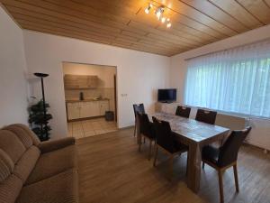a living room with a table and chairs and a couch at Haflingerhof Noack in Groß Klessow