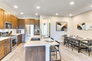 a kitchen with wooden cabinets and a large island with a sink at Brand-New Townhome with Hot Tub, 4 Mi to Winter Park in Fraser