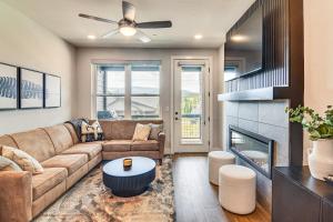 a living room with a couch and a fireplace at Brand-New Townhome with Hot Tub, 4 Mi to Winter Park in Fraser
