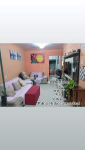 a bedroom with a large bed and a couch at Casa Rejane II Cop 30 in Ananindeua