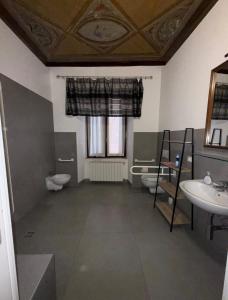 a bathroom with two toilets and a sink at Casa GILDA in Pisogne +8 photos