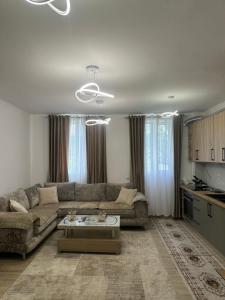 a living room with a couch and a table at Puka Retreat in Pukë