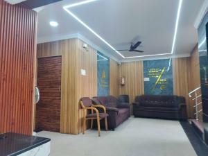 a living room with a couch and a chair at SPOT ON Srinivasa Residency in Tirupati