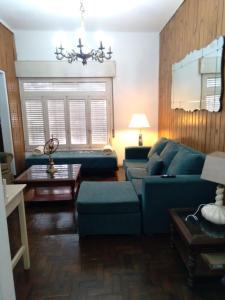 a living room with a blue couch and a table at La Dorada , Casa entera en Excelente Zona Residencial con cochera techada in Rosario