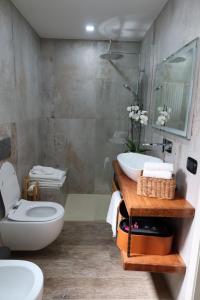 a bathroom with a toilet and a sink and a shower at Casa Nika in Parma +32 photos